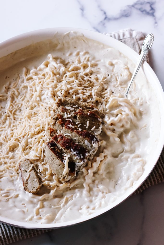 Skillet with creamy vegan chicken alfredo pasta